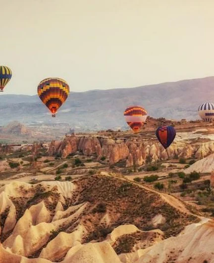 e4cdc12b-eac8-4f59-b084-1c9c74e90913-hot-air-balloon-flying-rock-landscape-turkey-cappadocia_146671-12695.jpg